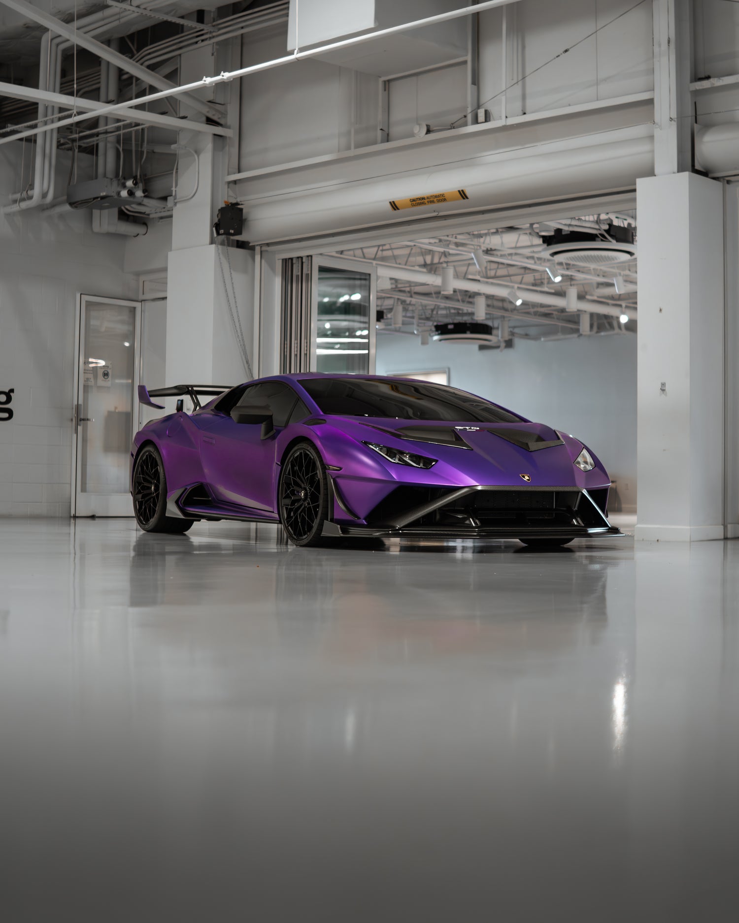 Simply Social AutoFest Indoor VIP Purple Sports Car in a garage Image.